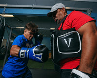 variant:lifestyle::TITLE Boxing Aerovent Elite Body Protector boy hitting right jab