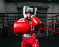 variant:black::TITLE Boxing Aerovent Elite USA Boxing Competition Headgear – With Cheeks kid throwing a right punch