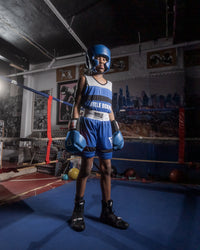 variant:blank blue::TITLE Boxing USA Boxing Competition Headgear - With Cheeks kid standing in ring