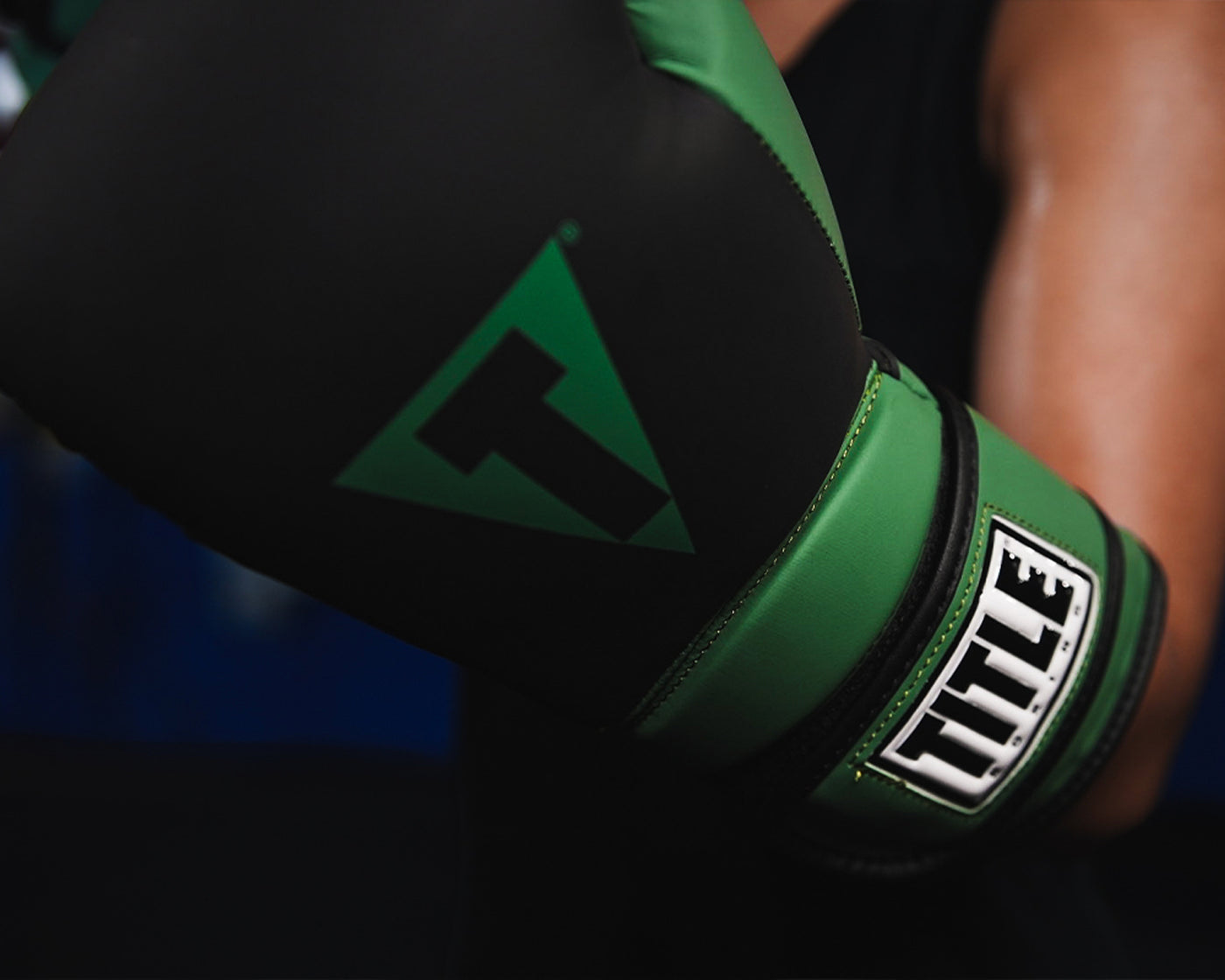 variant:Black/Blue::TITLE Boxing Conquest Training Boxing Gloves closeup on glove on fighter's hand