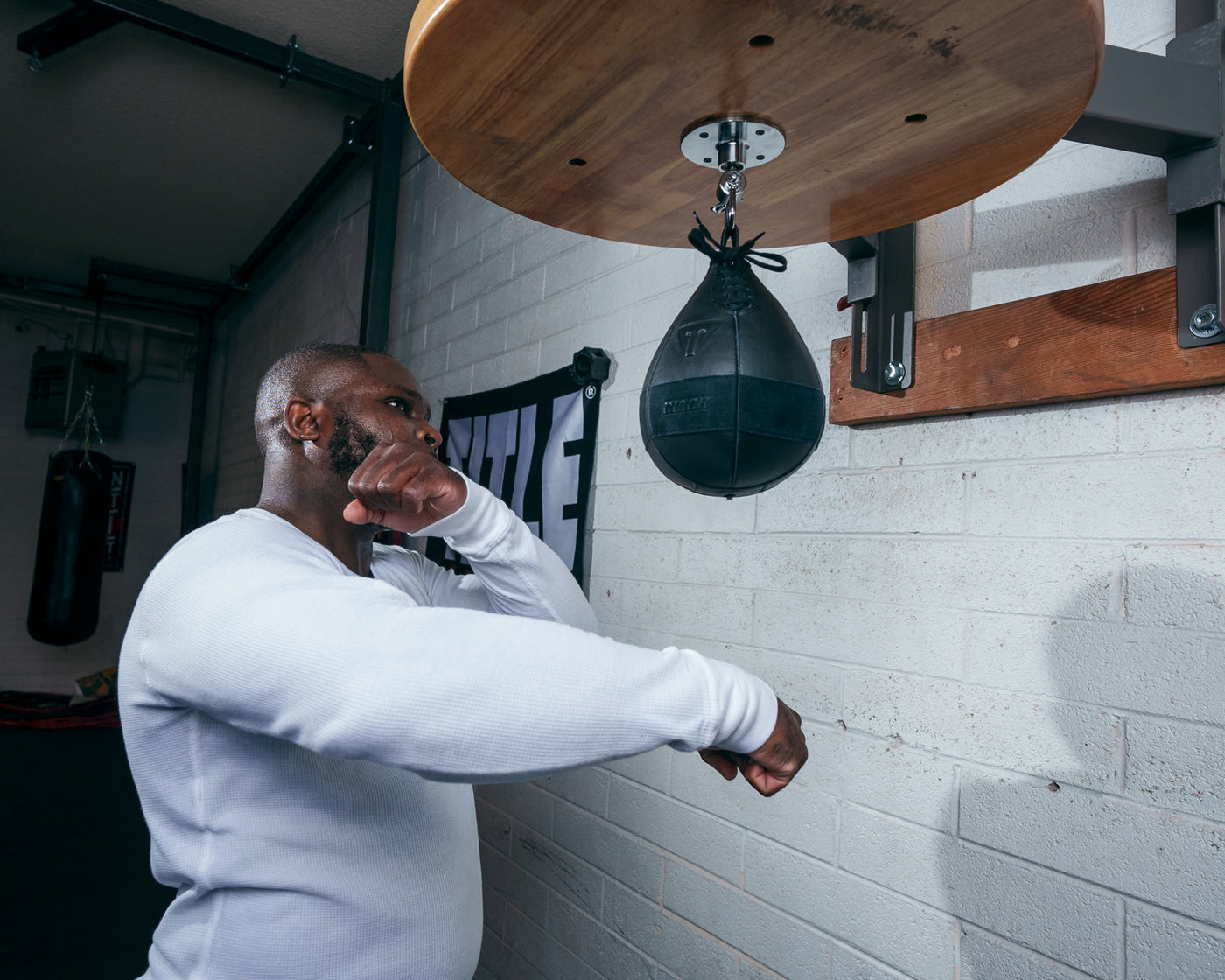 variant:lifestyle::TITLE Black Speed Bag 2.0 guy hitting speed bag