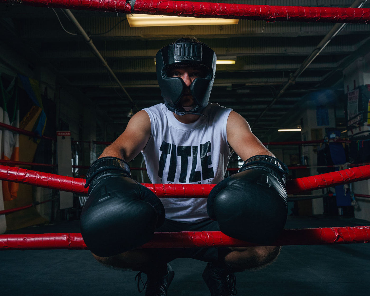variant:lifestyle::TITLE Black Training Headgear guy on ring ropes