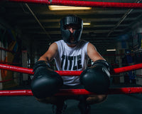 variant:lifestyle::TITLE Black Training Headgear guy on ring ropes