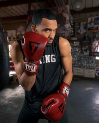variant:lifestyle::TITLE Boxing Blood Red Headgear and Sparring Gloves Bundle on boxer in the gym