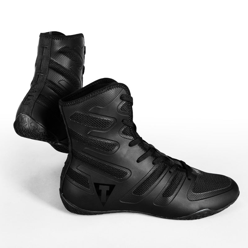 A pair of black high-top athletic boots with textured panels and laces, shown on a clean white background.