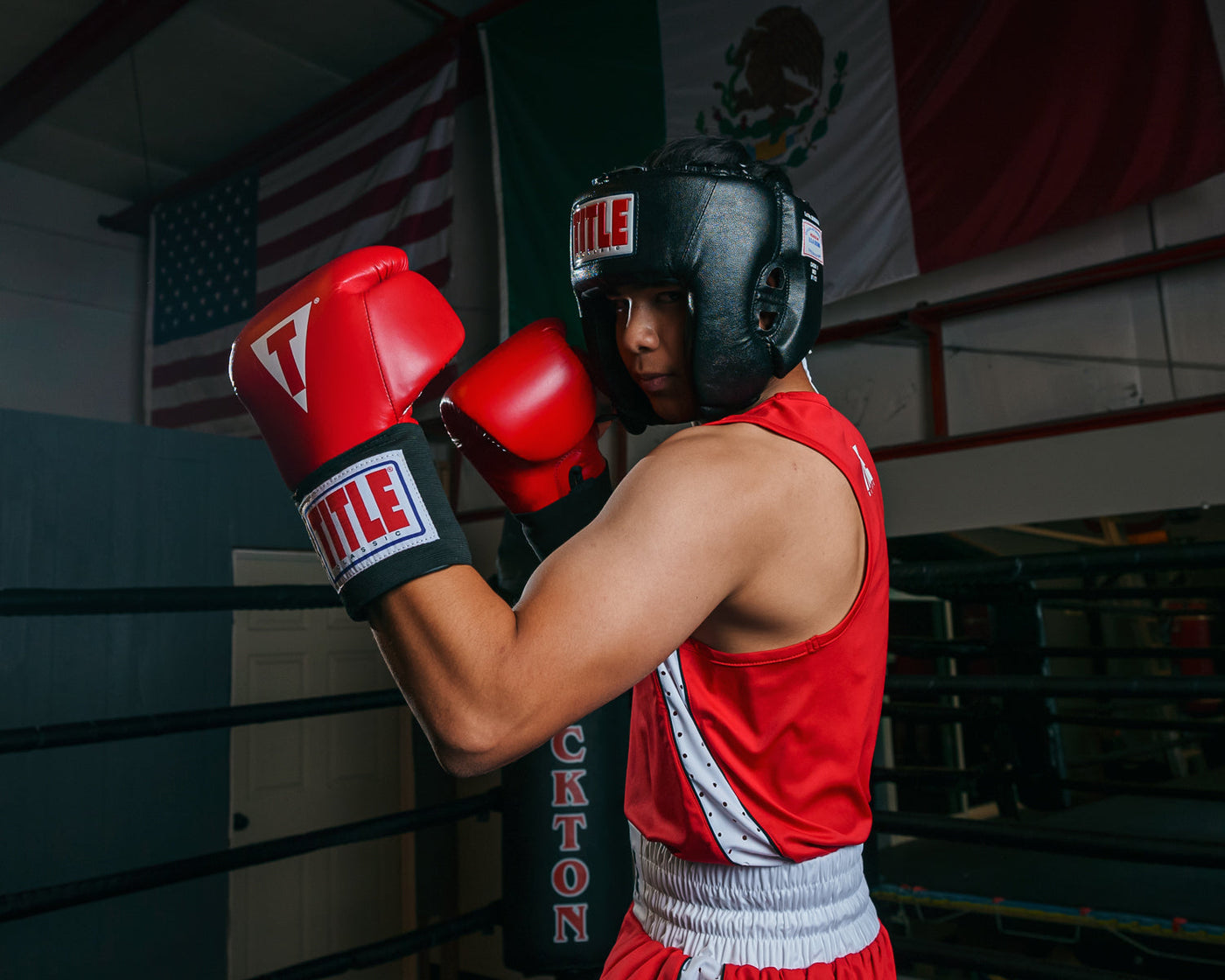 variant:black::TITLE Classic USA Boxing Competition Headgear- With Cheeks  kid in ring boxing stance