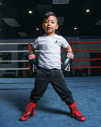 variant:lifestyle::TITLE Classic Black Max Boxing Gloves kid hands on hips
