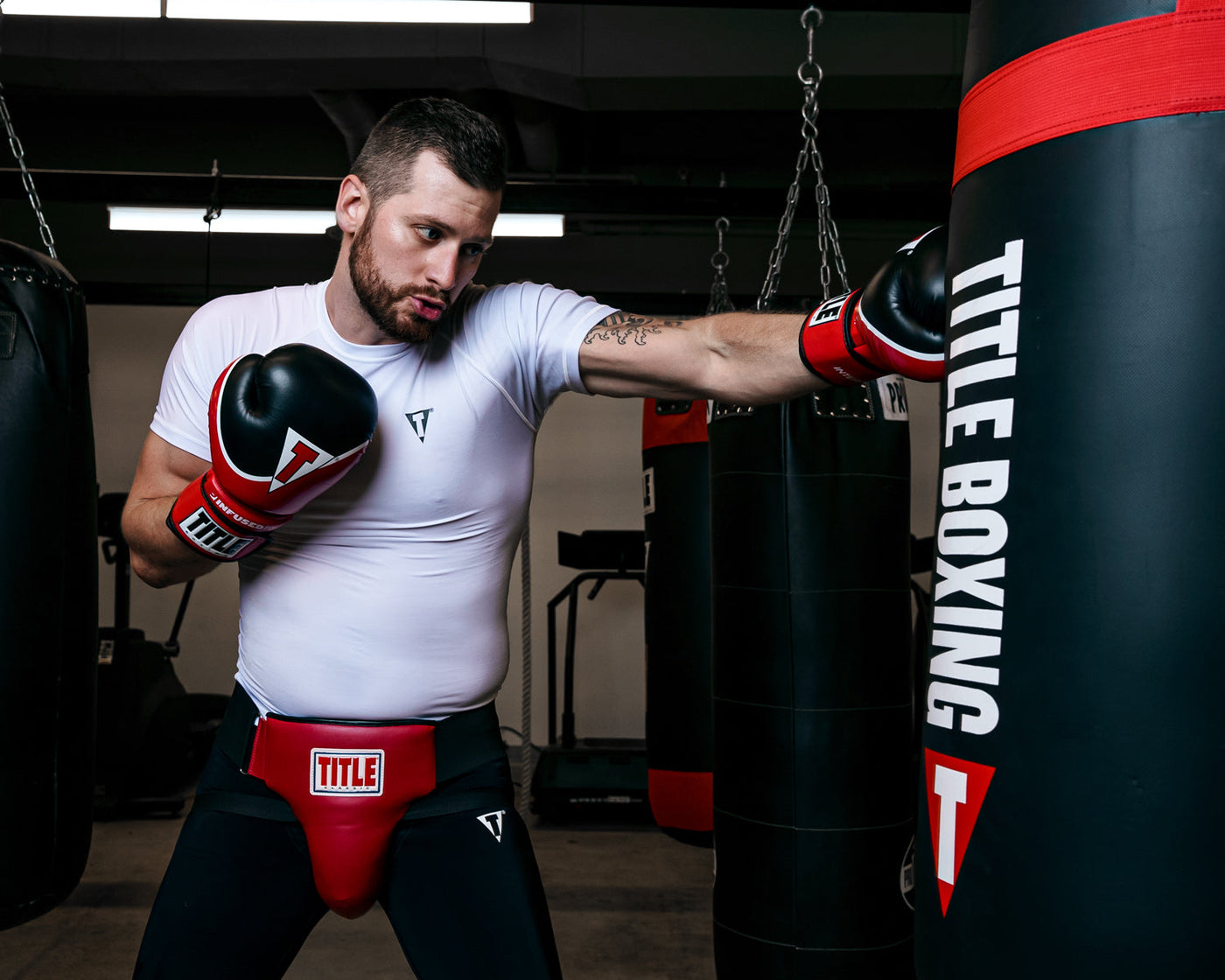 variant:lifestyle::TITLE Classic Groin Protector Plus 2.0 guy hitting bag