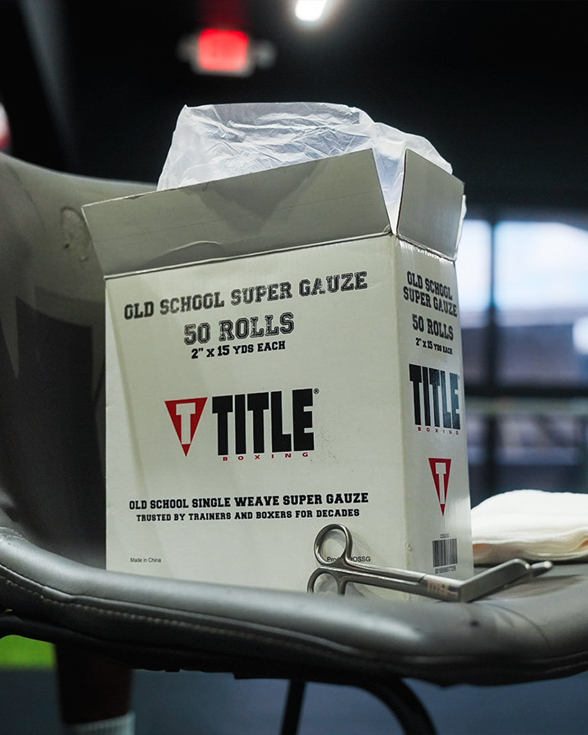 variant:lifestyle::TITLE Boxing Trainers Scissors resting on a box of boxing gauze