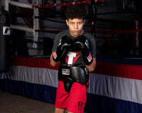 variant:black::TITLE Classic Super Bag Gloves 2.0 kid wearing protective cup and gloves