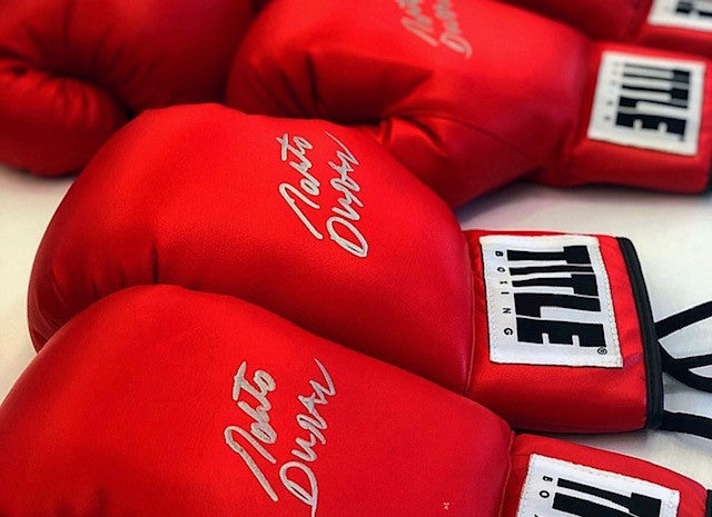 variant:red::TITLE Boxing Legacy Autograph Gloves 2.0 gloves on table