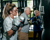 variant:lifestyle::TITLE Boxing Fight Back Boxing Gloves side view of class