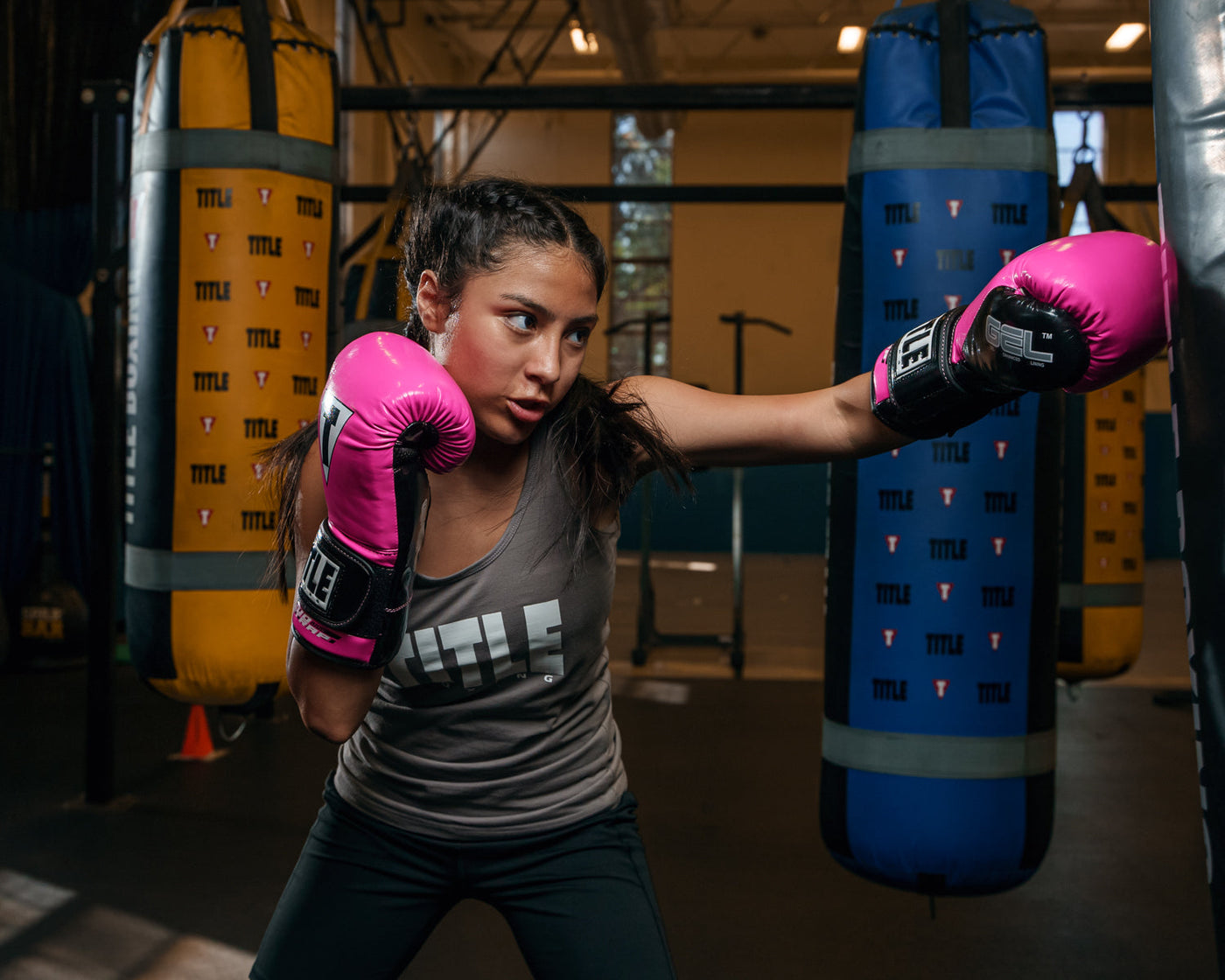 variant:Hot Pink/Black::TITLE Boxing Gel Glory Super Bag Gloves 2.0 girl left jab on bag