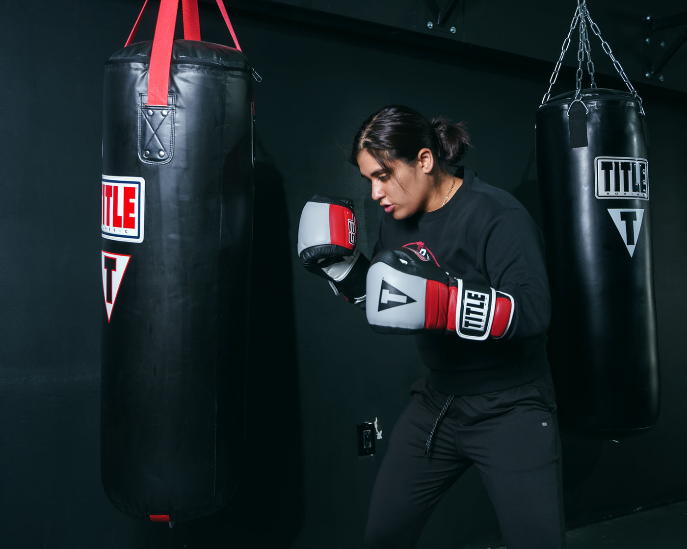 variant:Black/Grey/Red::TITLE Boxing Gel Rush Bag Gloves girl hitting bag