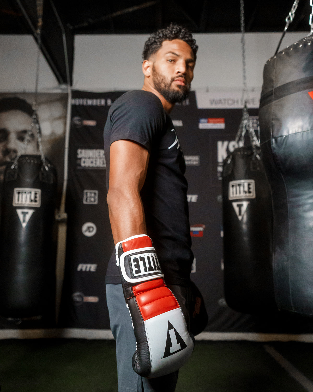 variant:Black/Grey/Red::TITLE Boxing Gel Rush Bag Gloves man posing with gloves