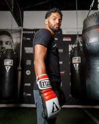 variant:Black/Grey/Red::TITLE Boxing Gel Rush Bag Gloves man posing with gloves