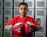 variant:Red::TITLE Boxing Gel World Bag Gloves boy posing with gloves