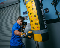 variant:black/gold::TITLE Boxing Gel World V2T Bag Glove guy hitting bag right jab