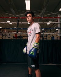 variant:navy/grey::TITLE Boxing Gel World V2T Bag Gloves kid posing with boxing gloves