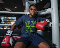 variant:red::TITLE Boxing Gel World Elastic Training Gloves kid sitting on ring