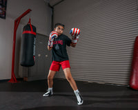 variant:lifestyle::TITLE Boxing Infused Foam Combat USA Training Gloves girl posing with boxing gloves