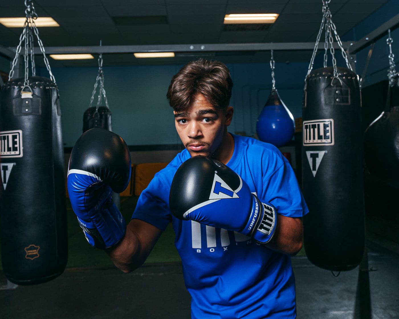 variant:blue/black::TITLE Boxing Infused Foam Interrogate Training Gloves 2.0 boxing pose
