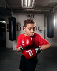 variant:red/black::TITLE Boxing Instinct Fitness Bag Gloves kid posing with boxing gloves