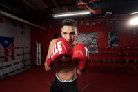 variant:Red/White::TITLE Boxing Inferno Intensity Elastic Training Gloves boy posing in ring