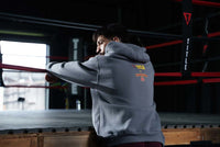 variant:Dark Grey::TITLE Boxing Legacy KRONK Training Camp Hoodie guy with back turned