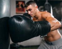 variant:black::TITLE Boxing Ko-Vert Bag Gloves guy wearing boxing gloves