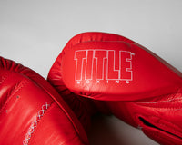 variant:red::TITLE Boxing Momentum Pro Bag Gloves closeup of logo on thumb