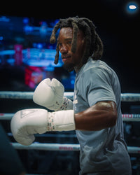 variant:white::TITLE Boxing Momentum Pro Sparring Gloves on boxer in the ring