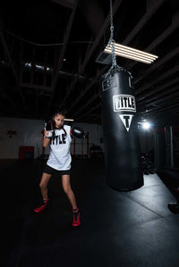 variant:lifestyle::TITLE Boxing Professional Choice 125lb Synthetic Leather Heavy Bag little girl hitting bag red shoes