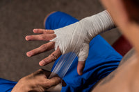 variant:lifestyle::TITLE Boxing Tape & Gauze Bundle boxer wrapping hand
