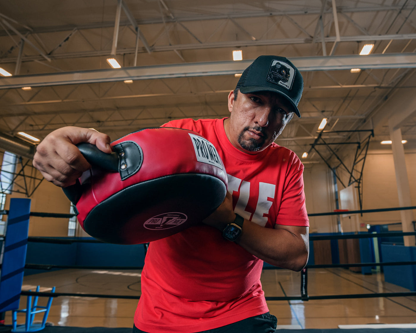 variant:lifestyle::Pro Mex Accuarcy Pro Punch Shield 2.0 coach holding down the shield motion