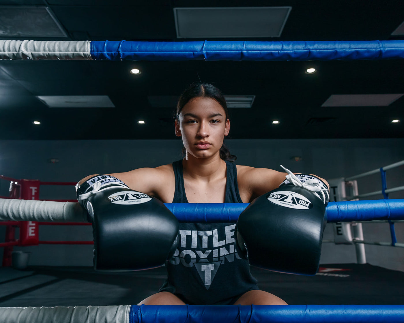 variant:Black/White::Pro Mex Professional Lace Sparring Gloves V3.0 girl sitting on ring