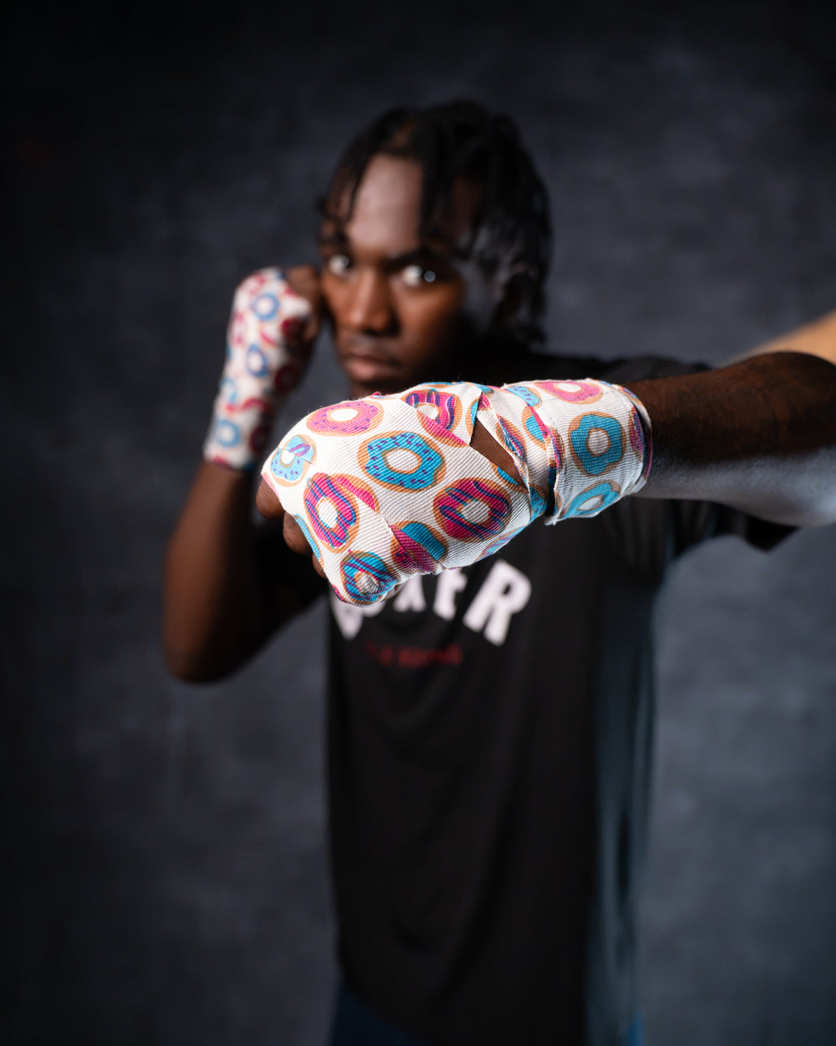variant:donuts::TITLE Boxing Print Mexican Style 180" Hand Wraps on boxer's hands in fighting stance