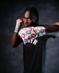variant:donuts::TITLE Boxing Print Mexican Style 180" Hand Wraps on boxer's hands in fighting stance