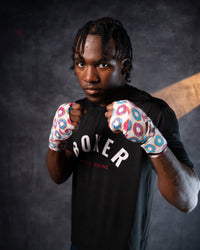 variant:donuts::TITLE Boxing Print Mexican Style 180" Hand Wraps on boxer's hands in fighting stance