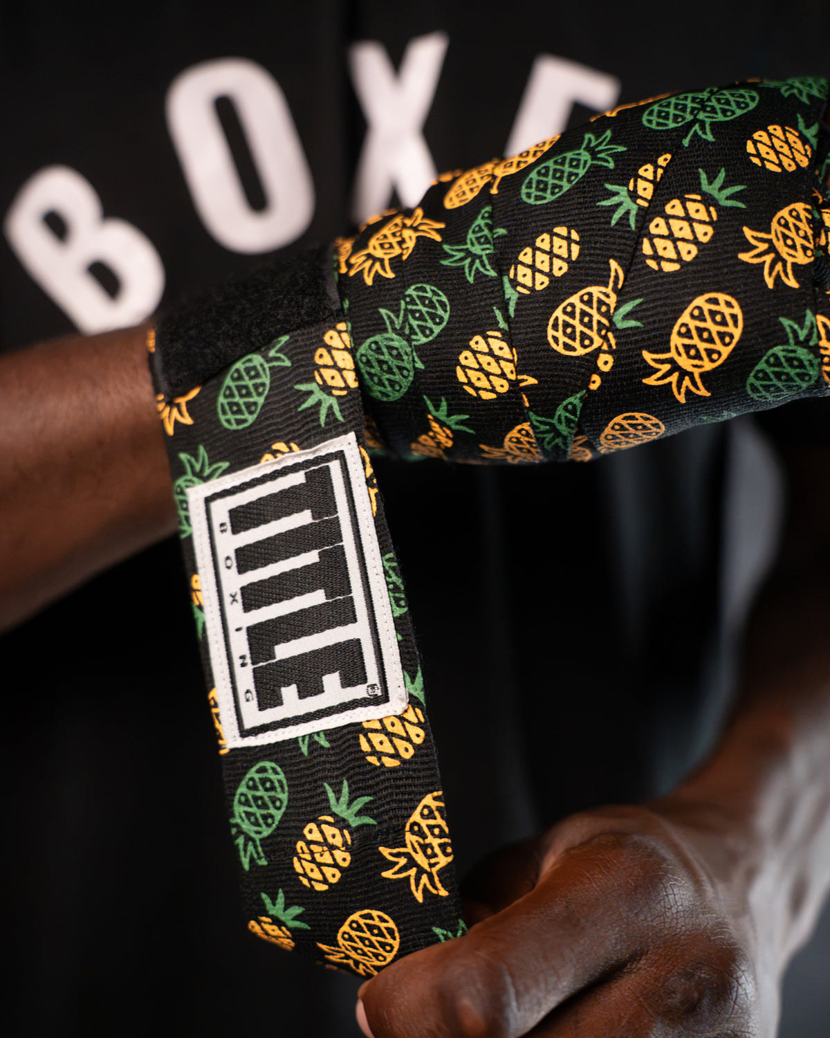 variant:pineapple::TITLE Boxing Print Mexican Style 180" Hand Wraps closeup on boxer's hand being wrapped