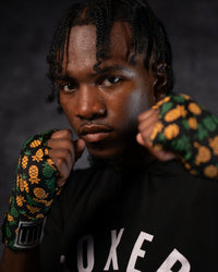variant:pineapple::TITLE Boxing Print Mexican Style 180" Hand Wraps on boxer's hands in fighting stance