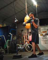 variant:lifestyle::TITLE Boxing Rubber Double End Bag Cable being used by boxer in the gym with double end bag
