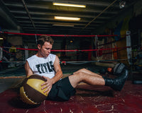 variantl:lifestyle::TITLE Boxing Retro Leather Medicine Balls  guy left  and right ball