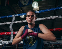 Variant:maroon::TITLE Boxing Select 180" Semi Elastic Mexican Hand Wraps guy making a fist