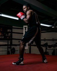 variant:black/white::TITLE Boxing Momentum Amateur Boxing Set guy in ring looking back