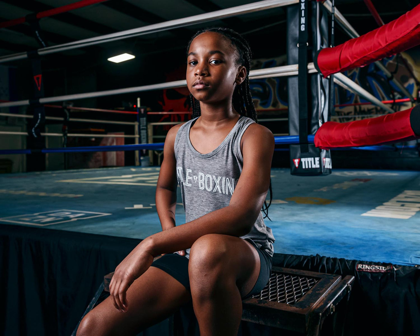 variable:Grey::TITLE Boxing Women's Ogio Luuma Tank girl posing sitting on boxing ring