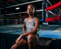 variable:Grey::TITLE Boxing Women's Ogio Luuma Tank girl posing sitting on boxing ring