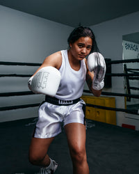 variant:white/black::TITLE Boxing Professional Women’s Satin Striped Boxing Trunks girl boxing stance