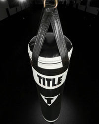 variant:Black/White::TITLE Boxing Made in the USA 135lb Thai Heavy Bag hanging in the gym