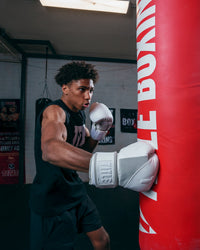 variant:lifestyle::TITLE White Boxing Gloves kid hitting bag